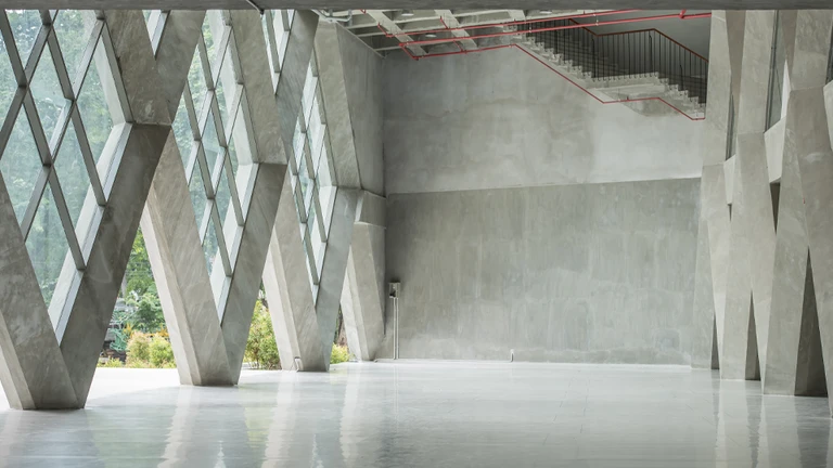 Modern empty loft with concrete floor and large windows